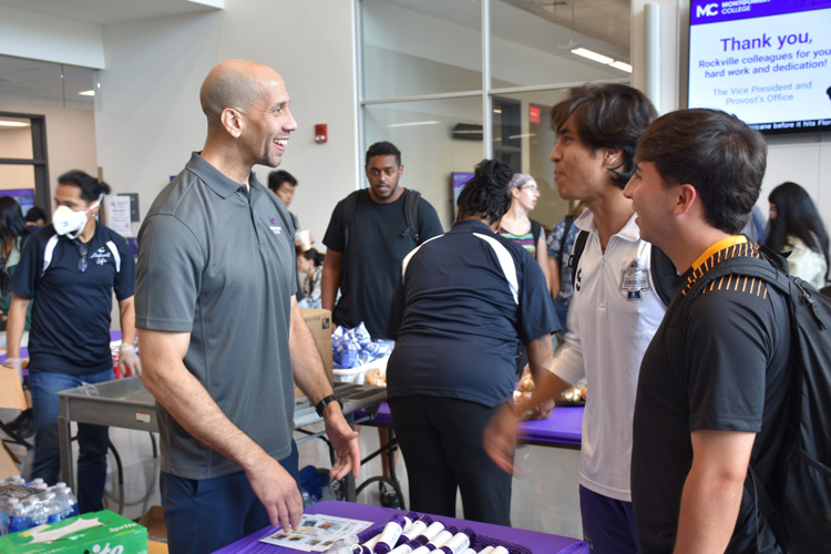 Dr. Williams with students at the Student Services Building.