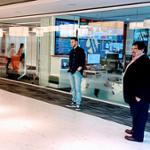 student and teacher outside office glass partitions on field trip to Marriott International Headquarters