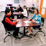 two students in chairs doing mock interview