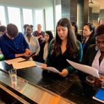 students looking at printed materials during Tour of the Canopy by D.C., the Wharf Hotel 