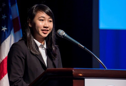 A female student at a podium