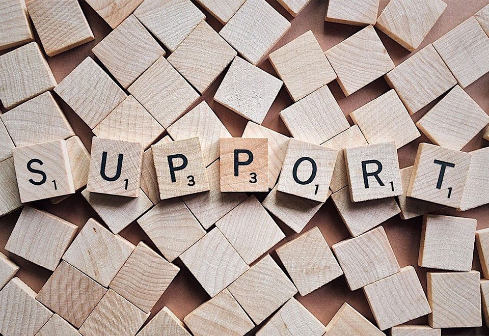 scrabble tiles spelling out "Support"