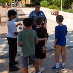 public safety officer talking with children outside