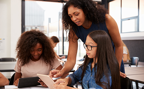 Female High School teacher with students. 