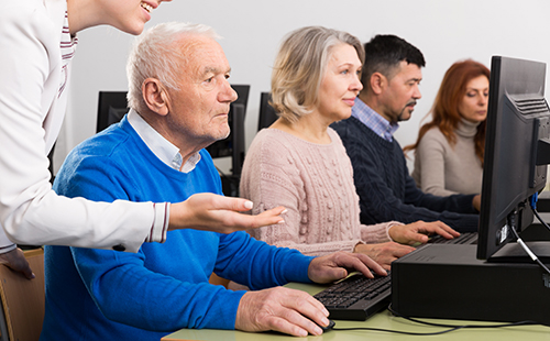 Adults taking a class in a computer lab