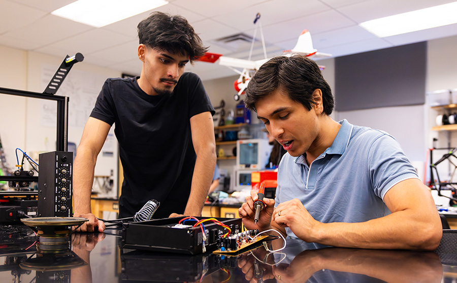 Marco working on a project in an engineering lab with a fellow student